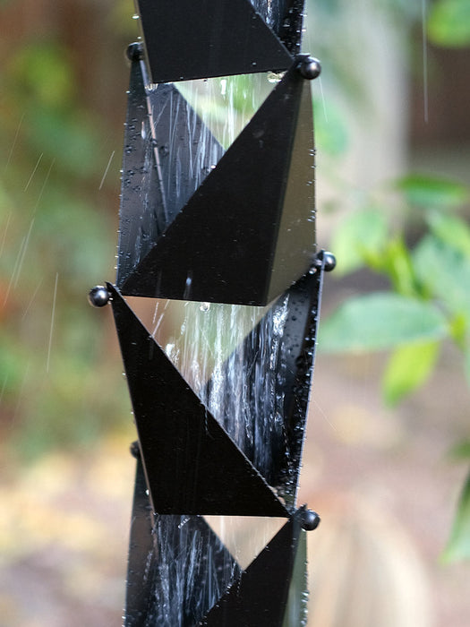 Matte black Origami square-cup rain chain installed on a modern home