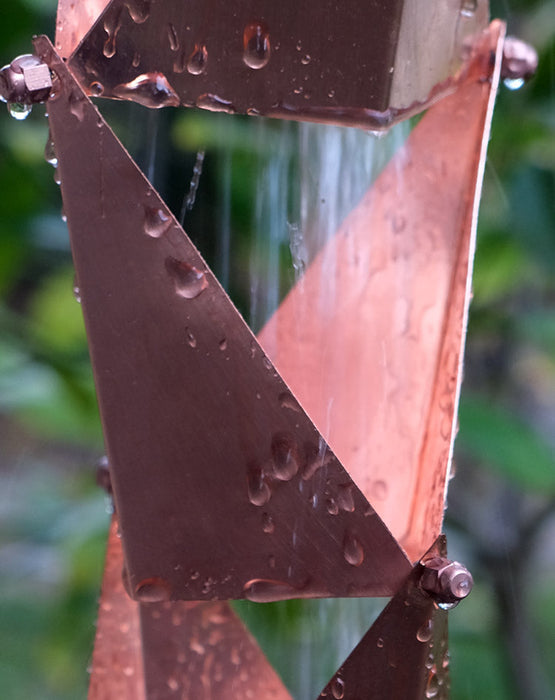 Copper Origami square-cup rain chain carrying water in heavy flow