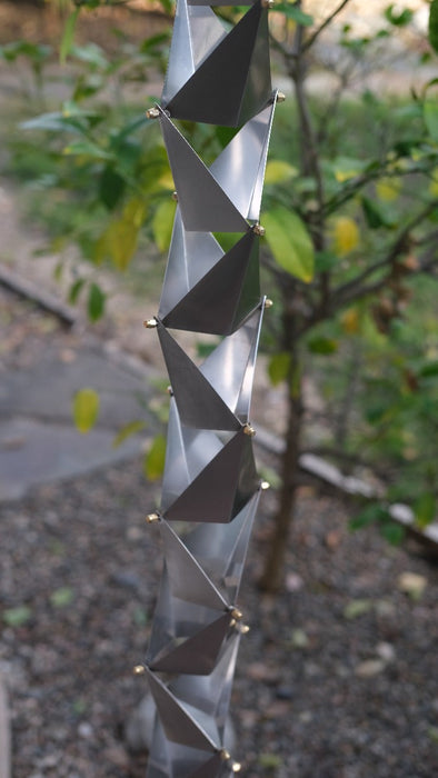 Close view of brushed steel Origami rain chain cups