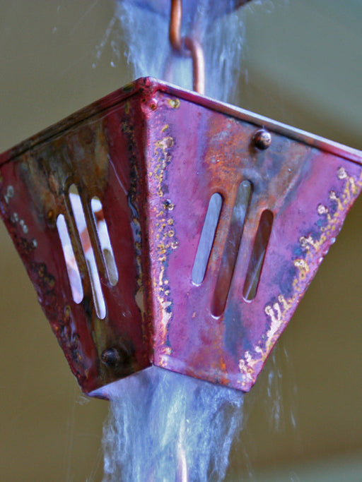 Hand-welded slotted square copper rain chain with torch-aged finish
