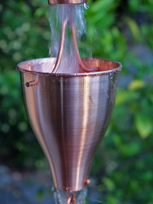 Smooth copper cup rain chain for heavy tropical rainfall in Hawaii
