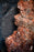 detail display large black tourmaline crystal highly streaked with orange mica