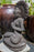 seated concrete buddha black finish praying mudras halo full lotus