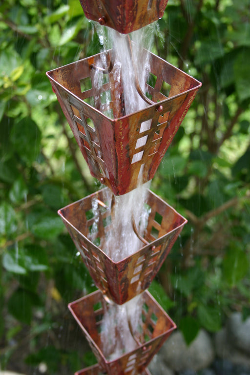 Handcrafted square copper rain chain cups with Arts & Crafts geometric cutouts