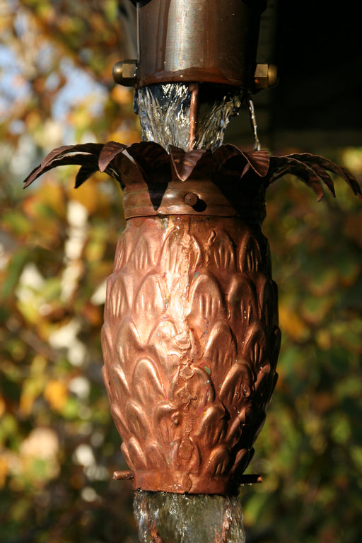 Hand-tooled pineapple cup detail on pure copper rain chain